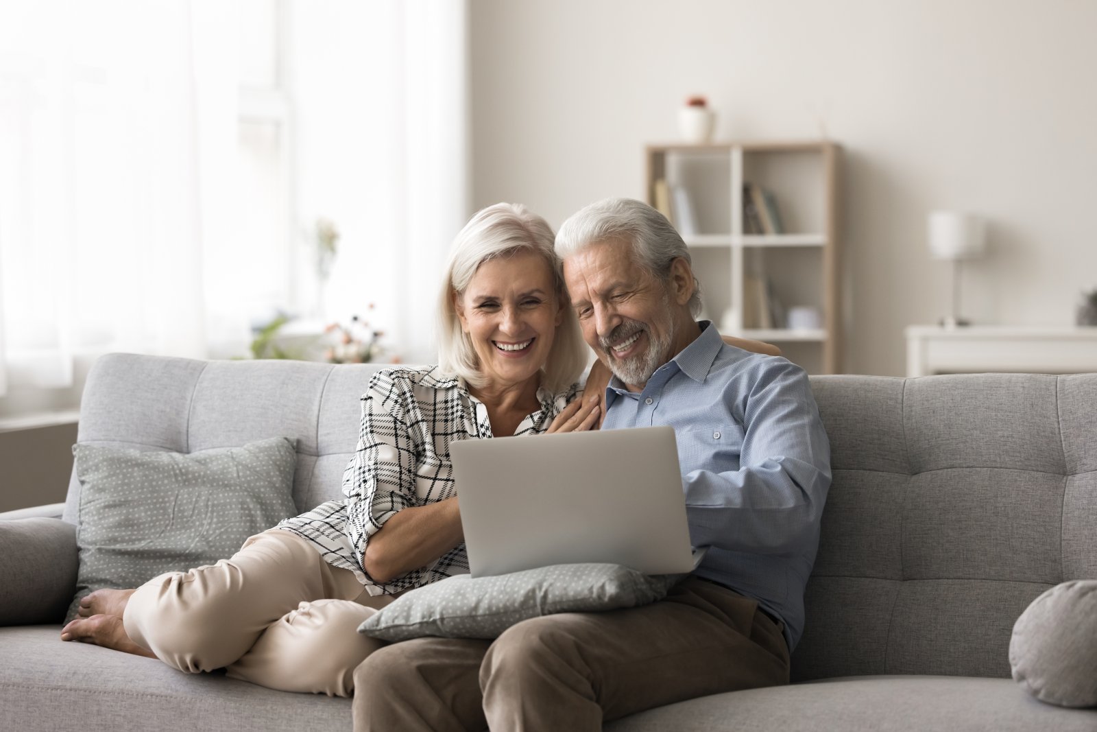 A couple reviewing information together on a laptop